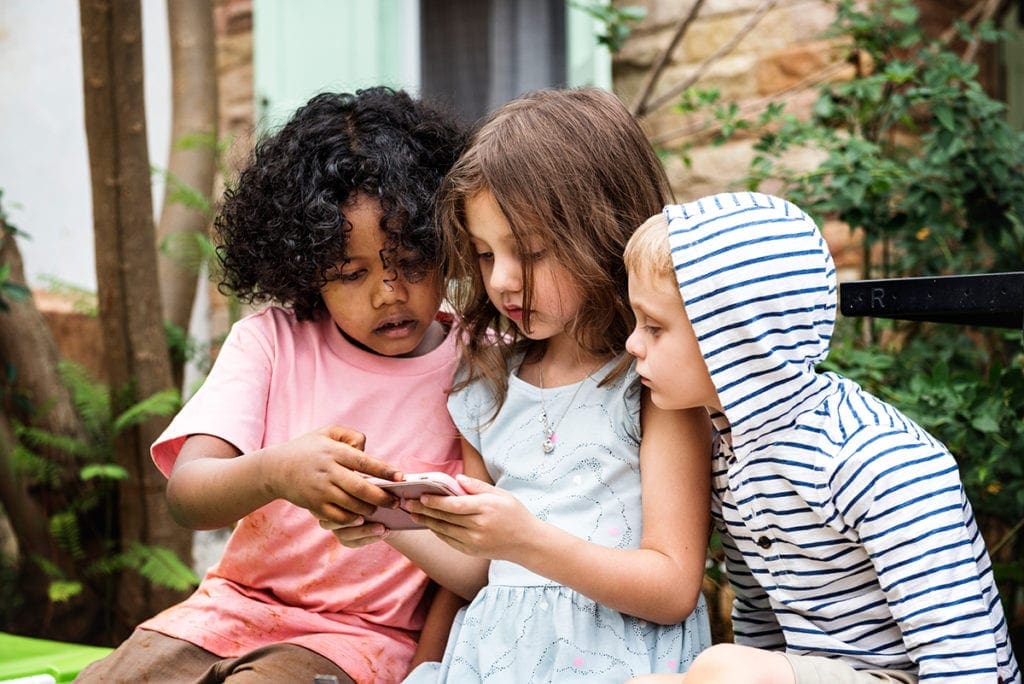 Children playing video games on a smartphone