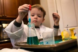 Child with a science experiment kit