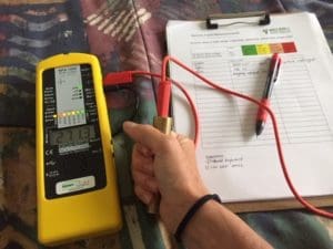 The person being evaluated holds on to the probe, then the meter measures the difference of the voltage between the person and the earth.