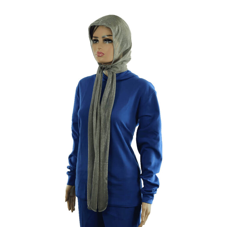 Woman in blue outfit and gray hijab modeling minimalist clothing on white background
