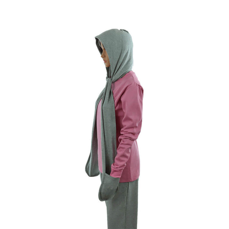 Person in pink hoodie and gray sweatpants standing sideways, wearing a gray hooded scarf draped over their head and shoulders