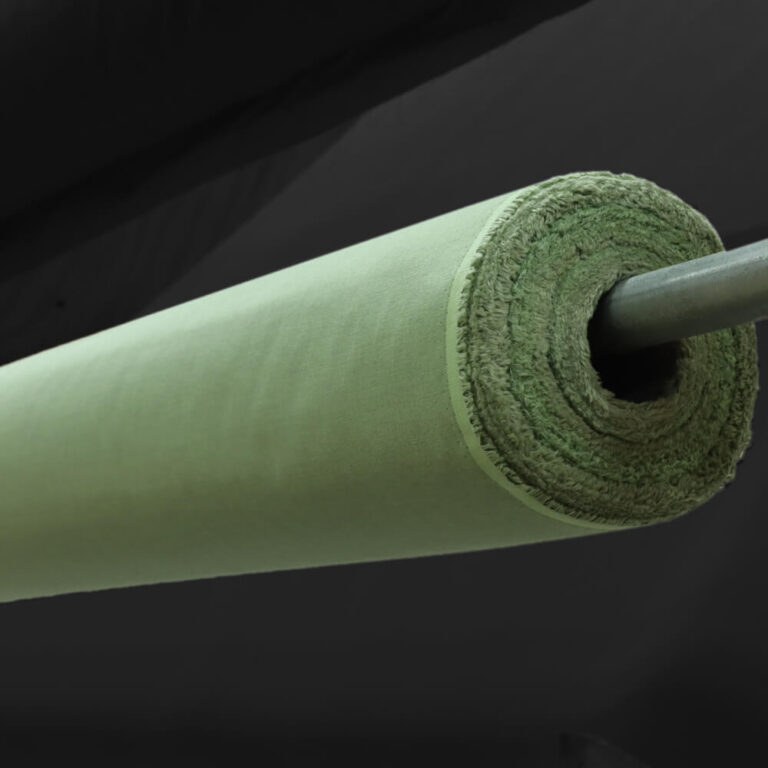 Green foam roller in closeup against dark background, highlighting texture and cylindrical shape of EMF protection product.