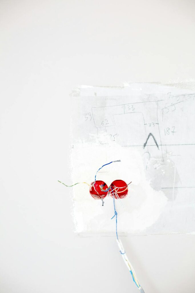 Home electrical outlet and wiring on white wall representing where dirty electricity travels through your home